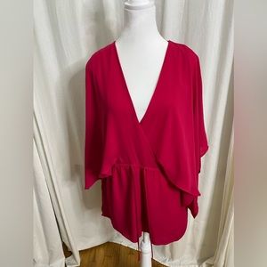 Romper has flowing sleeves. The shorts are lined and 100% Polyester